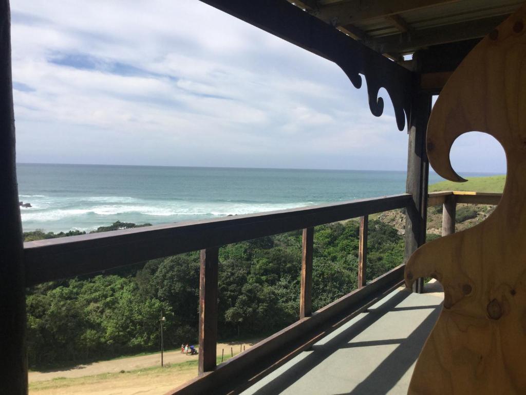 a view of the ocean from the balcony of a lighthouse at CORAM DEO SaltyWaves double en-suite rooms with sea views in Coffee Bay
