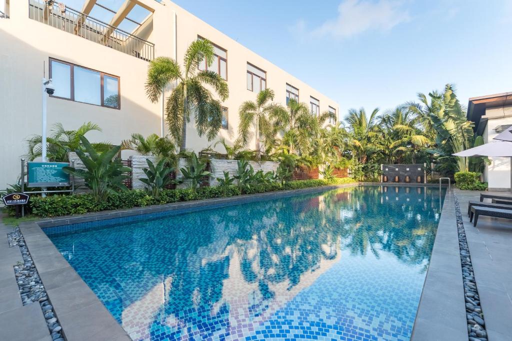 a swimming pool in front of a building at Iccssi Villa Haitang Bay Sanya in Sanya