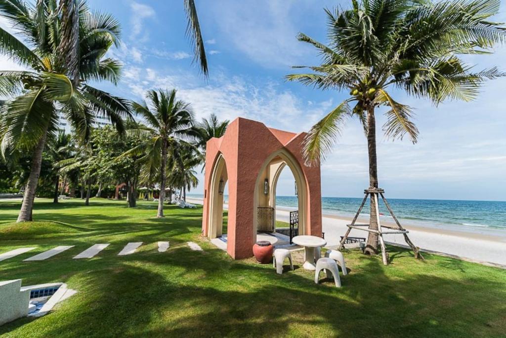 a small chapel on the beach with palm trees at Marrakesh Huahin 1 bedroom with pool access 307 in Hua Hin