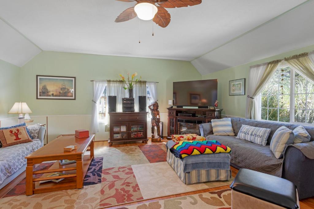 a living room with a couch and a table at Sunset Beach Cottage in Bandon