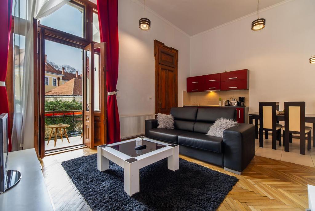 a living room with a couch and a table at Select City Center Apartments in Braşov