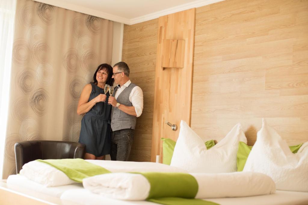 a man and a woman standing in a hotel room at Riegersburgerhof in Riegersburg