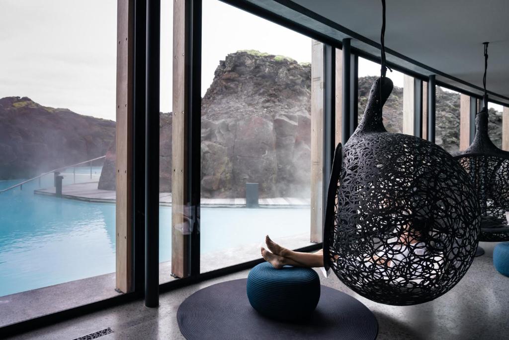 a person sitting on a ball in front of a window at The Retreat at Blue Lagoon Iceland in Grindavík