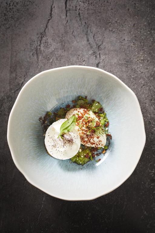 a white bowl with three hard boiled eggs in it at The Retreat at Blue Lagoon Iceland in Grindavík