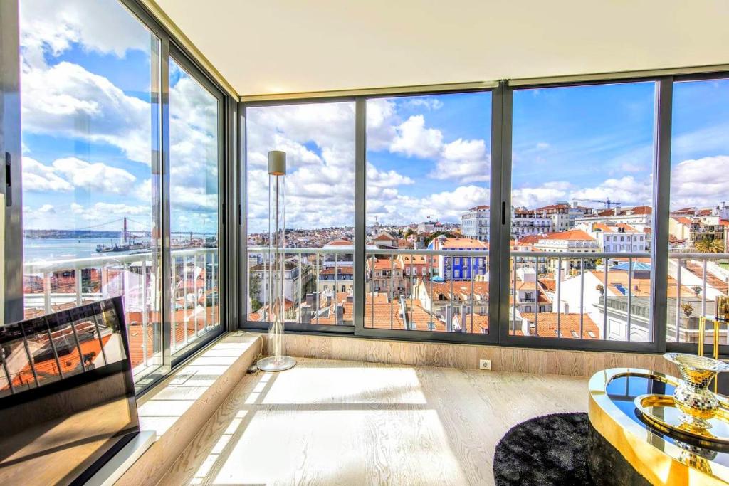 Elegant rooftop terrace in Lisbon’s Alfama with sweeping views over the Tagus River and red-tiled rooftops, representing the calibre of properties protected by thorough legal due diligence.