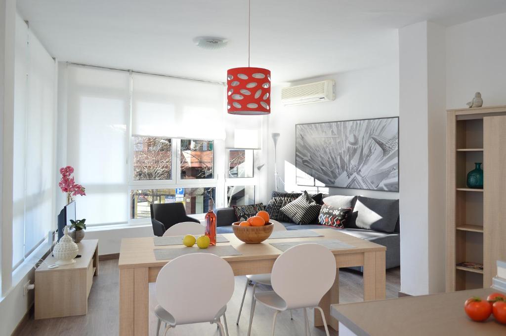 a kitchen and living room with a table and chairs at CIUDADELA PARK 1 in Barcelona