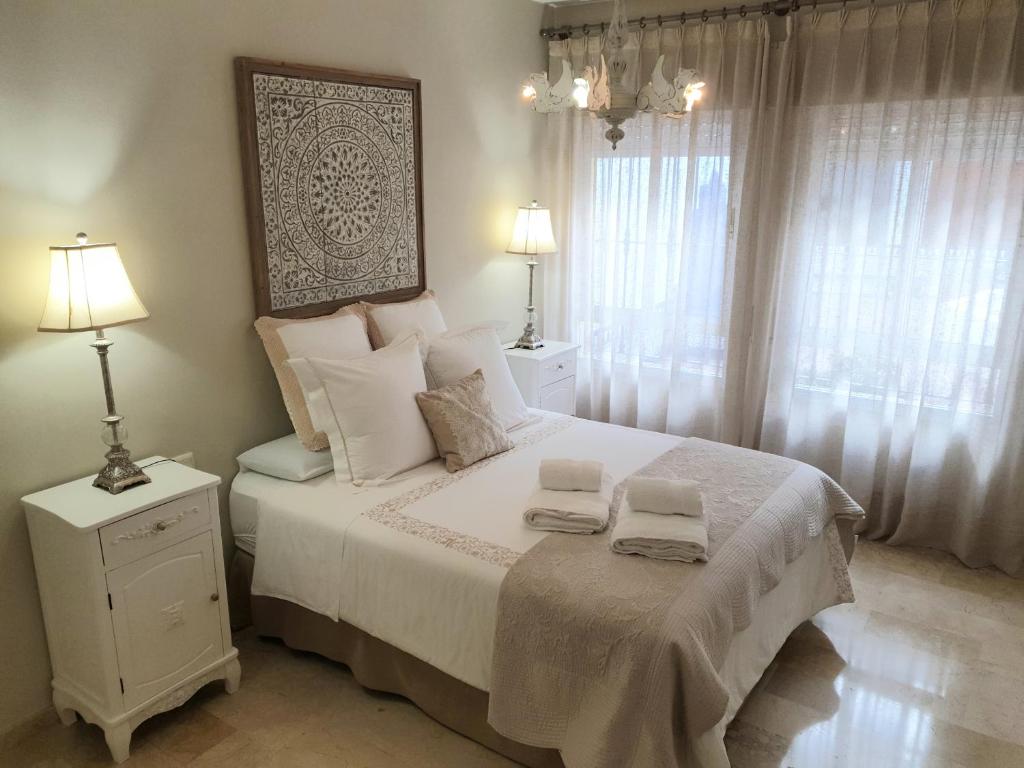 een slaapkamer met een bed met twee handdoeken erop bij Apartamento La Judería de San Clemente in Sevilla