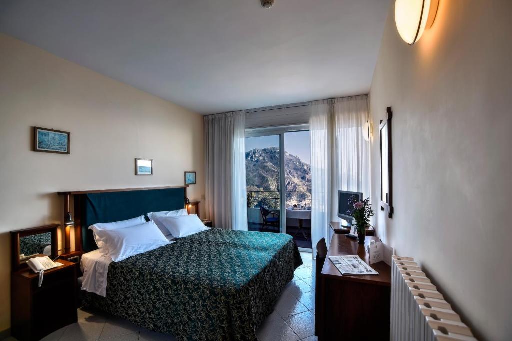 Postel nebo postele na pokoji v ubytování Hotel Graal
