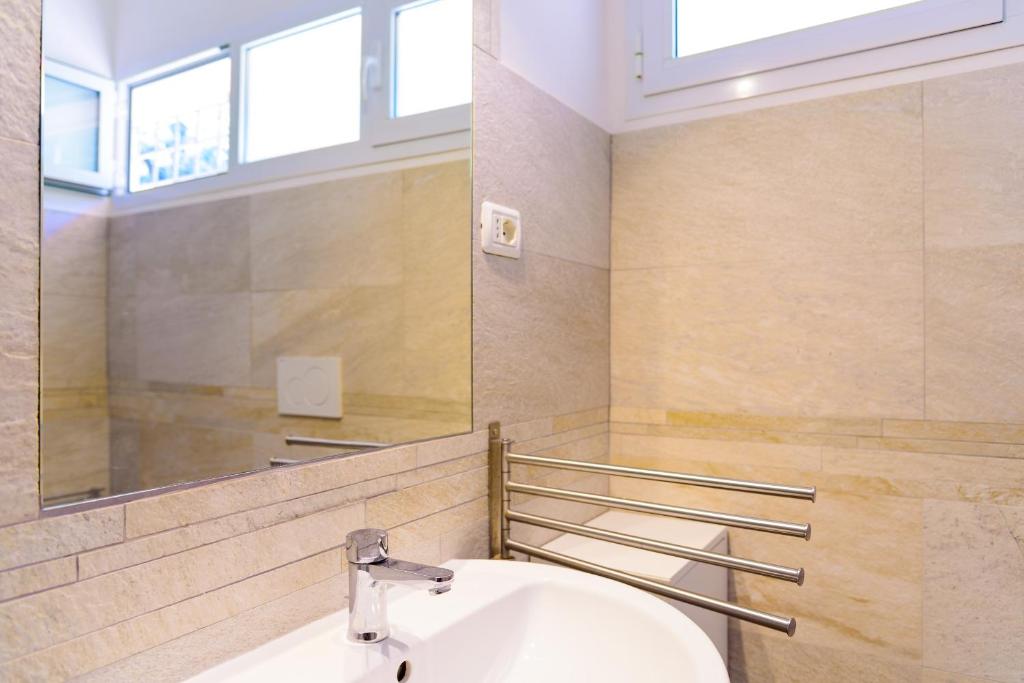 a bathroom with a sink and a mirror at Villa I Coralli in Portoferraio