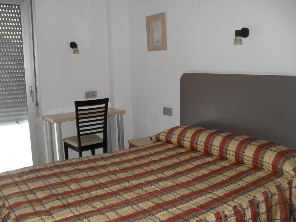 Postel nebo postele na pokoji v ubytování Hostal San Marcos