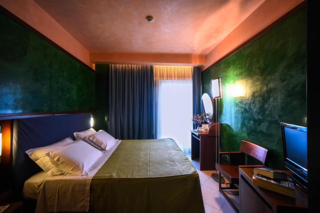 Postel nebo postele na pokoji v ubytování Hotel Graal