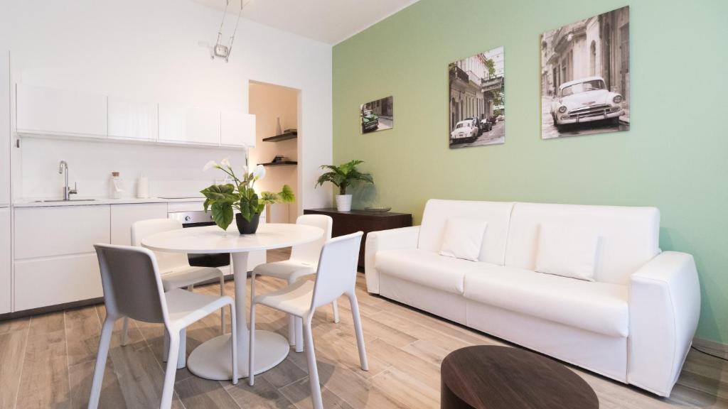a living room with a table and a white couch at Italianway - Merlo 3 in Milan