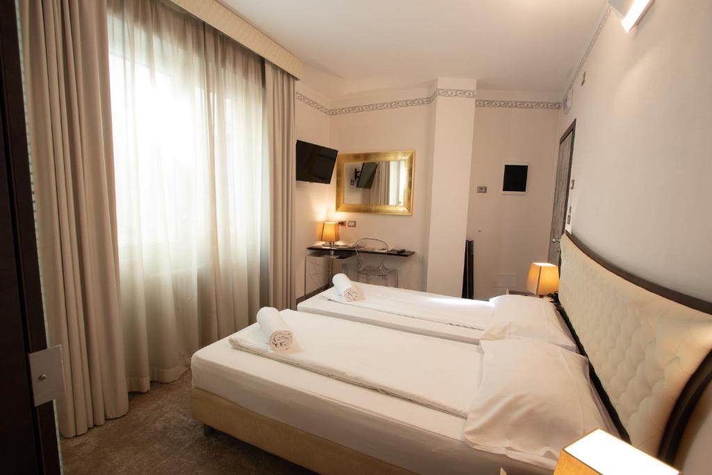 Postel nebo postele na pokoji v ubytování Hotel Corona
