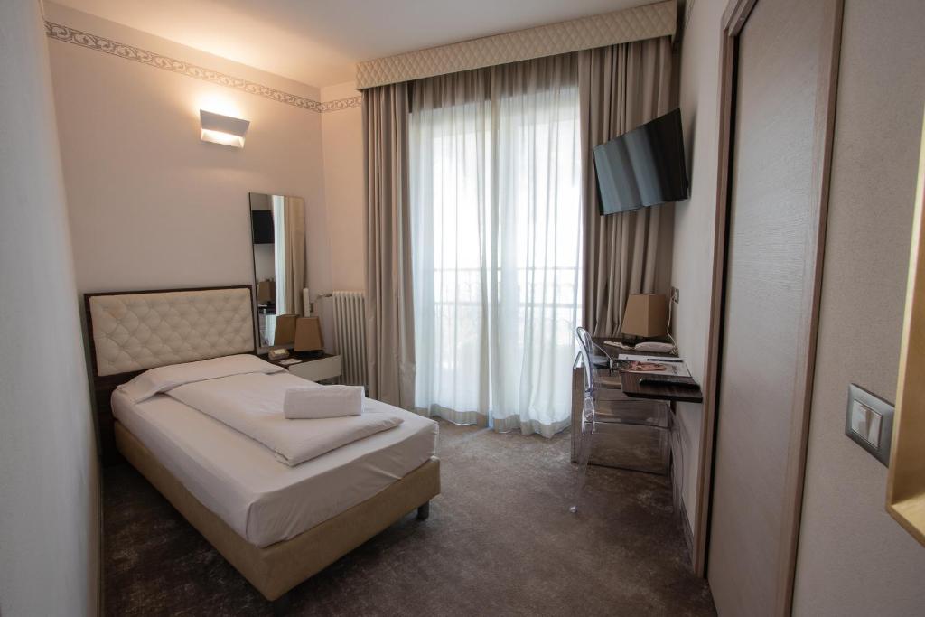 Postel nebo postele na pokoji v ubytování Hotel Corona