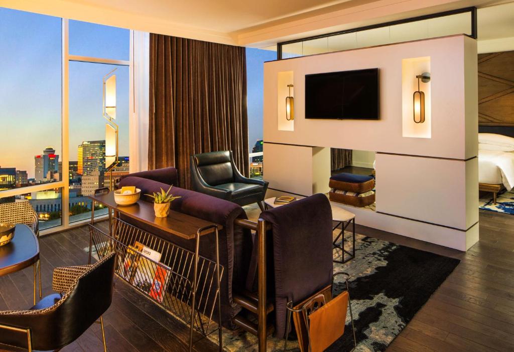 a hotel room with a bed and a television at Thompson Nashville, by Hyatt in Nashville