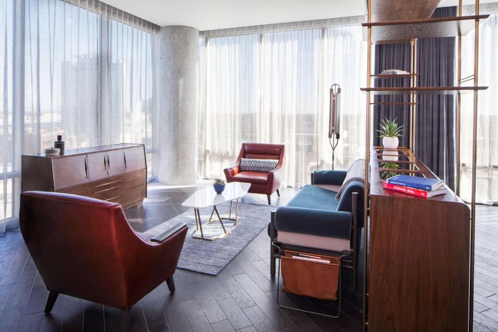 a living room with a couch and chairs in a building at Thompson Nashville, by Hyatt in Nashville