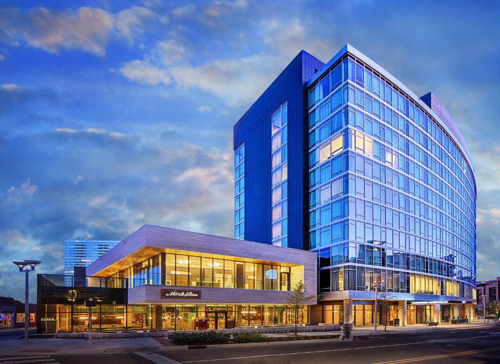 a large blue glass building with a lot of windows at Thompson Nashville, by Hyatt in Nashville