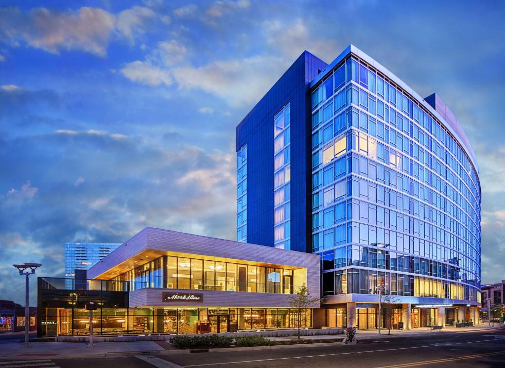 a large blue glass building with a lot of windows at Thompson Nashville in Nashville