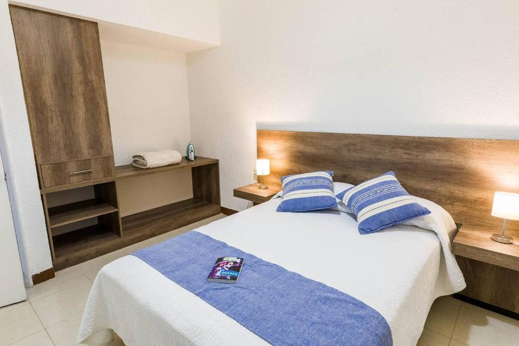 - une chambre avec un grand lit et des oreillers bleus dans l'établissement Oaxaca at your doorstep (3), à Oaxaca