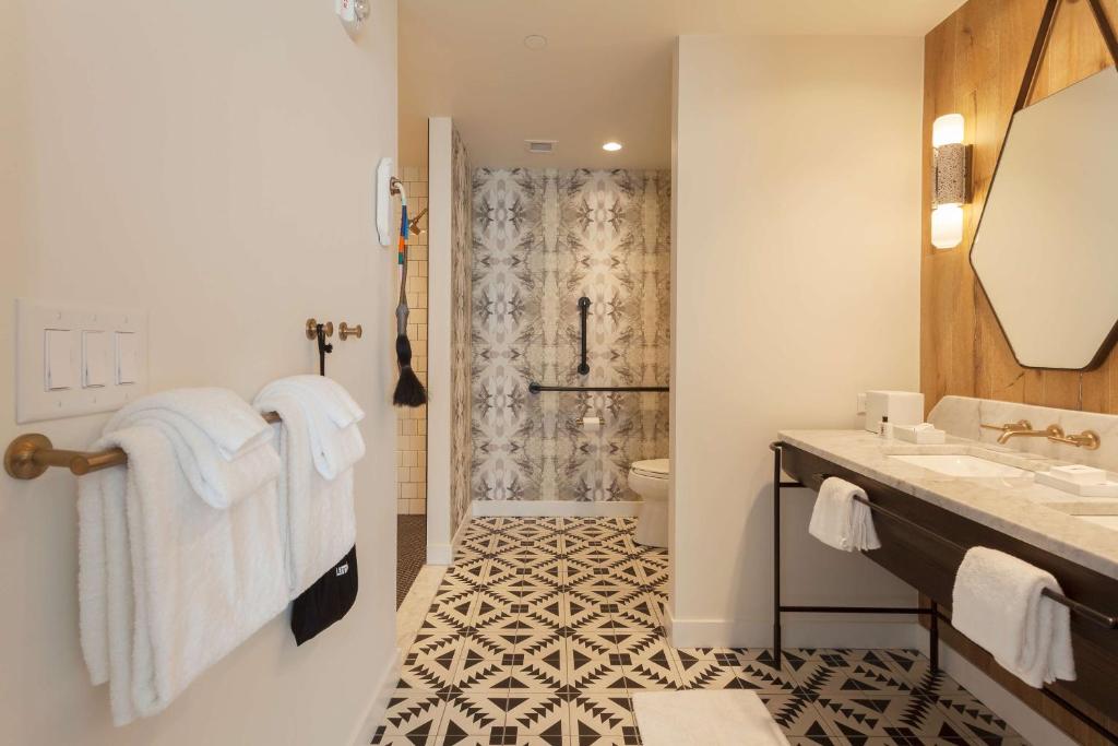 a bathroom with a sink and a shower at Thompson Nashville, by Hyatt in Nashville