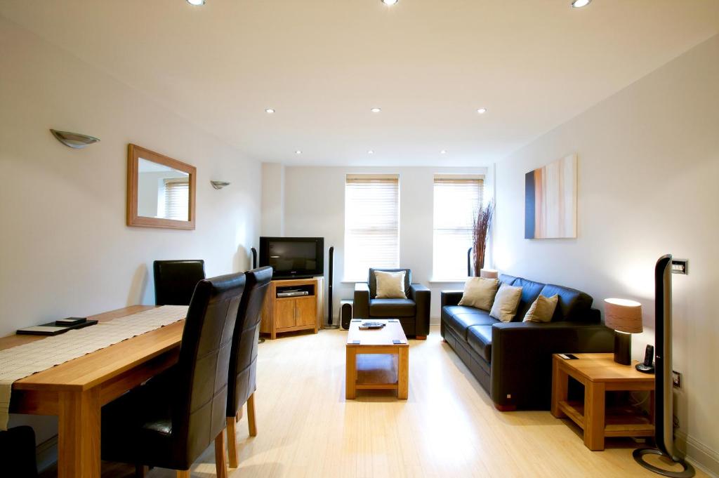 a living room with a couch and a table at 2 bed 2 bath at Pelican Hse in Newbury - FREE secure, allocated parking in Newbury