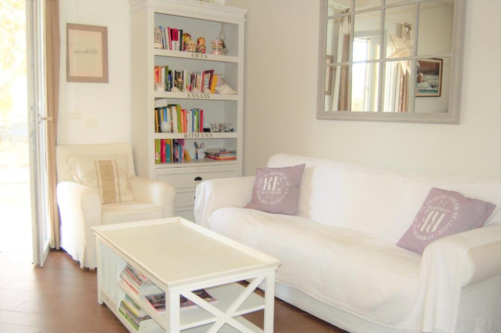 een woonkamer met twee witte banken en een tafel bij Villa Garden in Siracusa