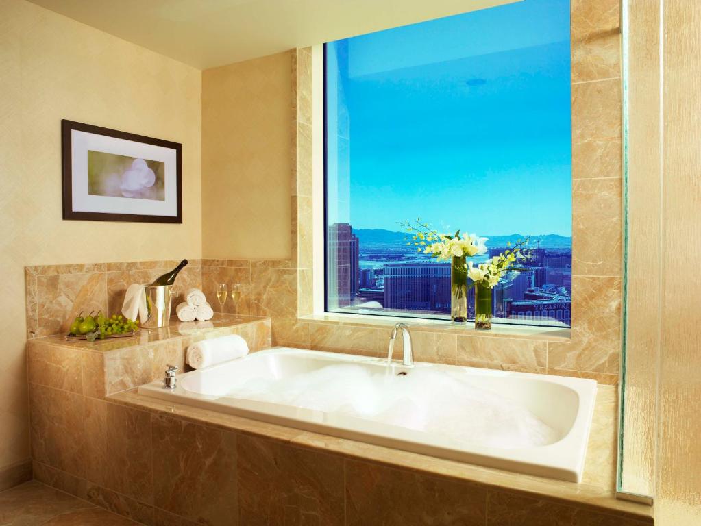 
a bath room with a tub and a window at Trump International Hotel Las Vegas in Las Vegas

