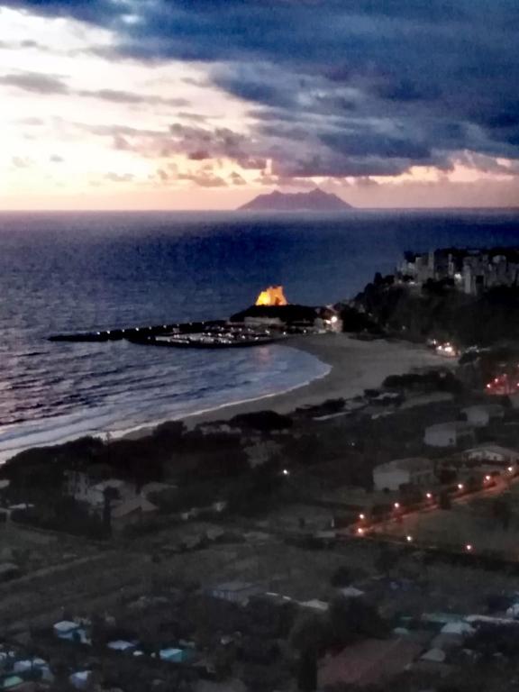 a view of a beach at night with the ocean at Valeri 's Country House in Sperlonga