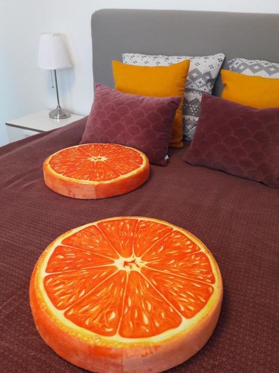 an orange cut in half sitting on a bed at Hamina Orange Apartments Loft in Hamina