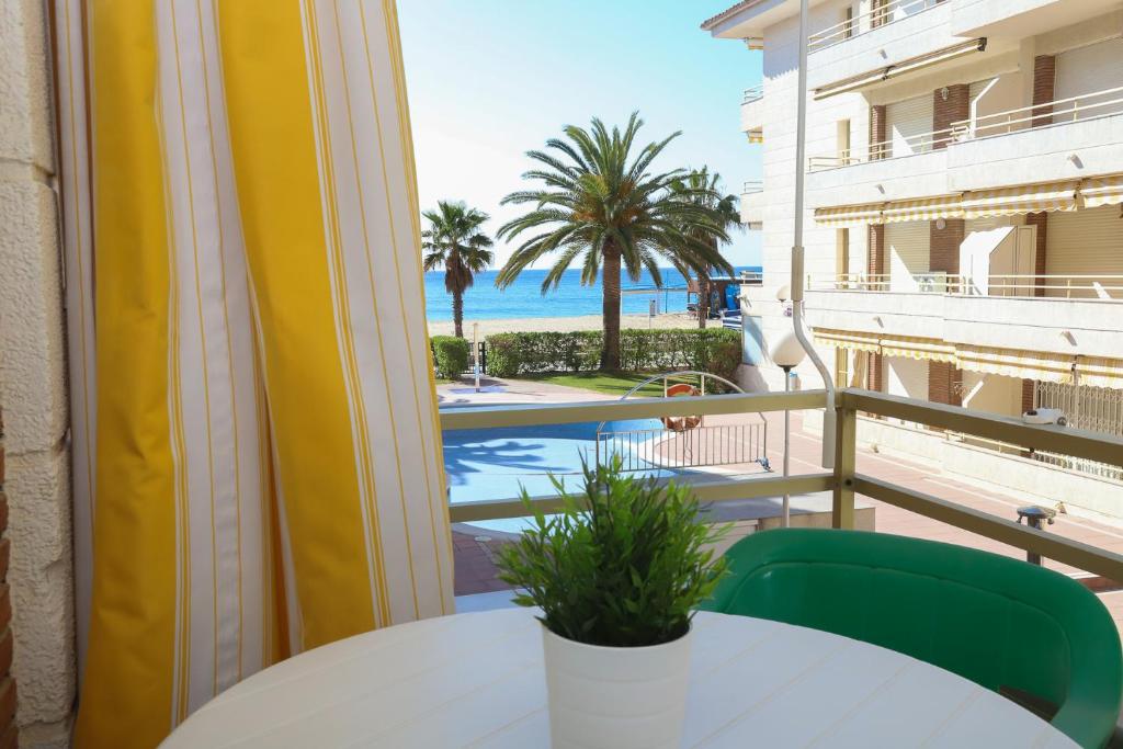 a balcony with a table and a view of the ocean at COSTA DAURADA APARTAMENTS - Colibri Beach in Cambrils