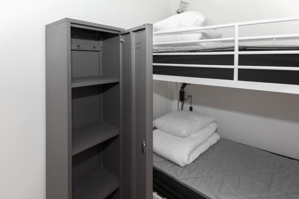 a room with two bunk beds with white pillows at City Backpackers Hostel in Stockholm