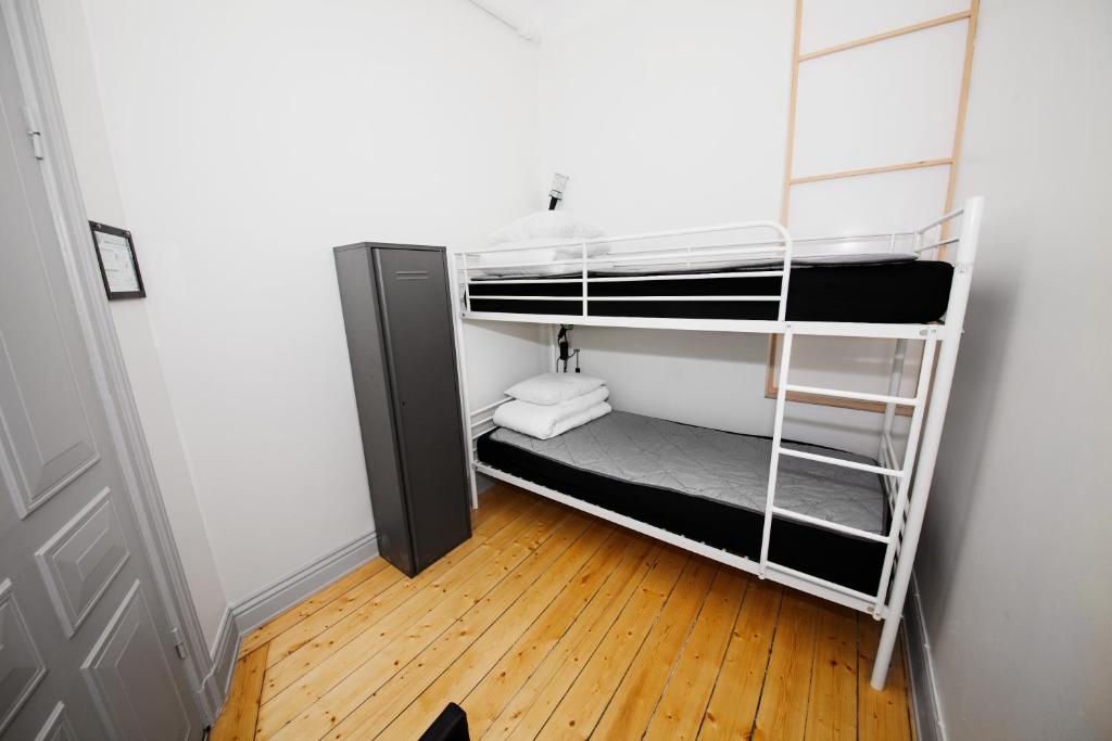 a room with two bunk beds with a wooden floor at City Backpackers Hostel in Stockholm