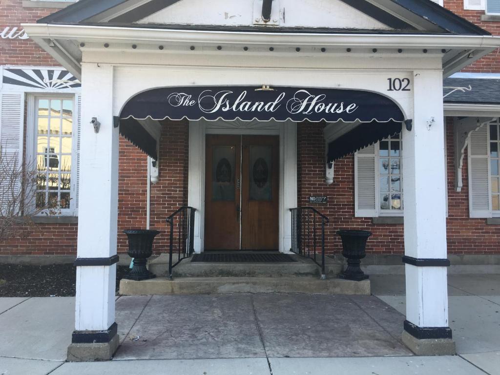 a building with a sign on the front of it at The Island House Hotel in Port Clinton