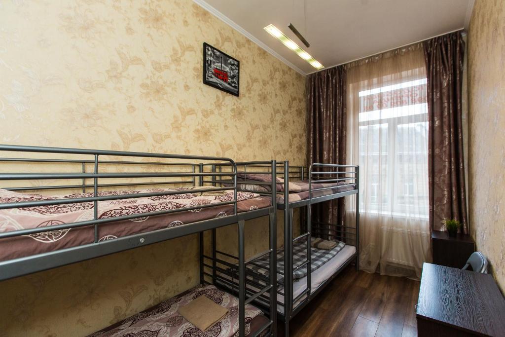 a room with two bunk beds and a window at Baker's street in Lviv