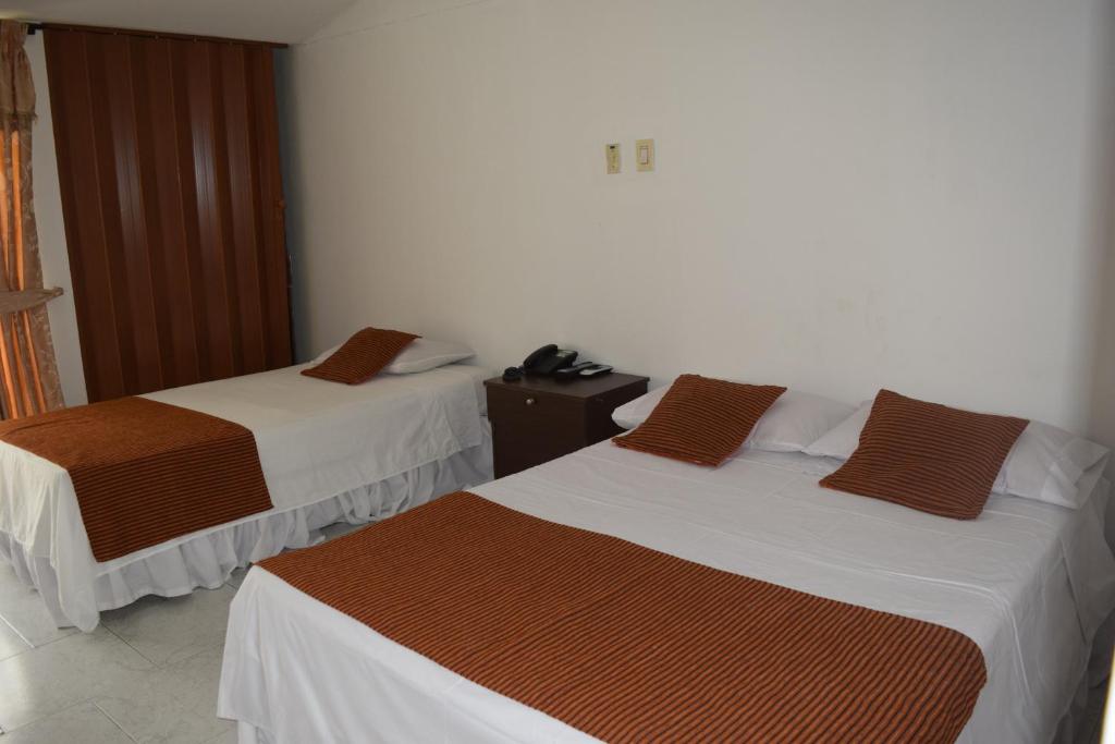 Una cama o camas en una habitación de Hotel Las Victorias Palmira