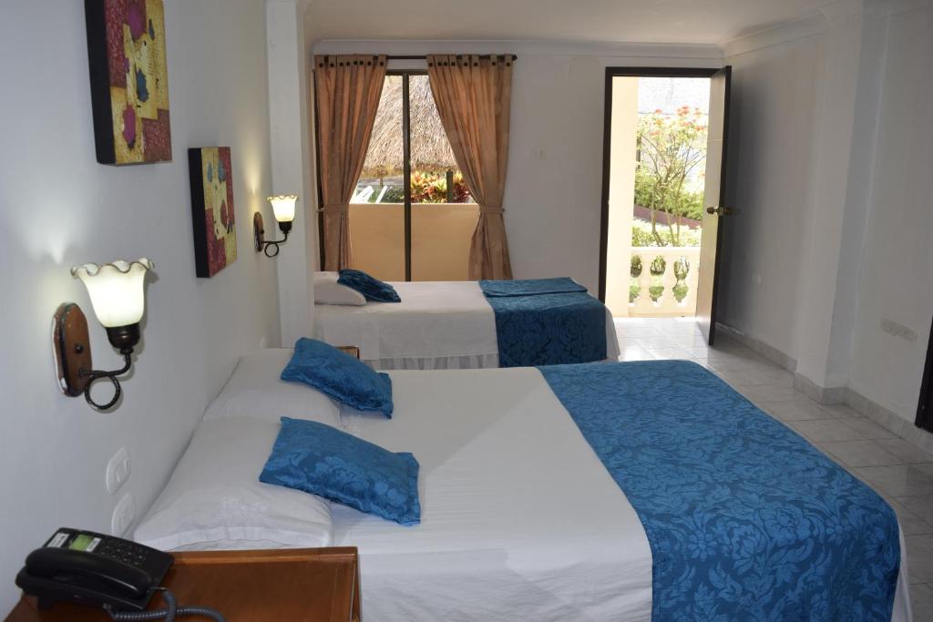 Una cama o camas en una habitación de Hotel Las Victorias Palmira
