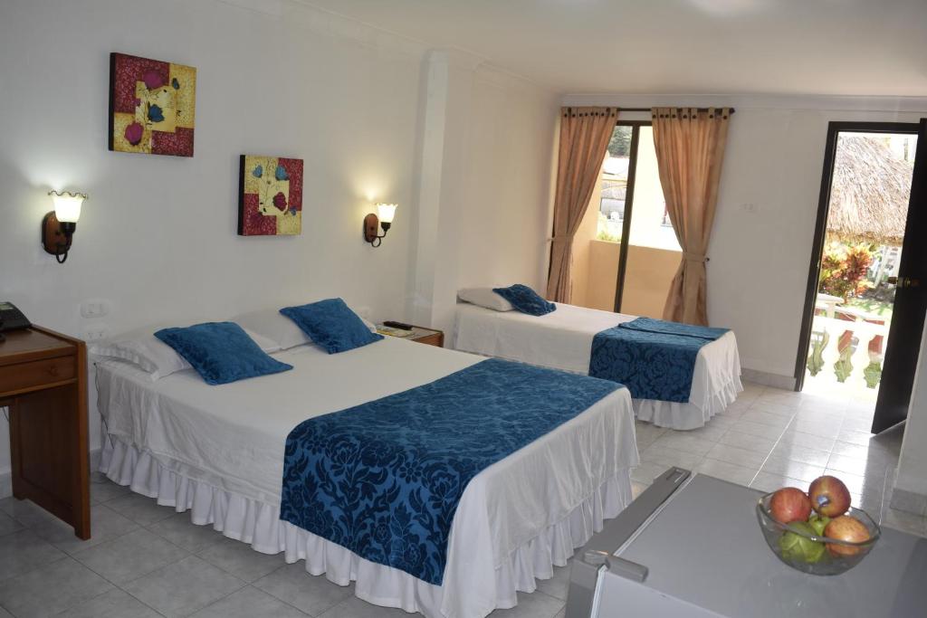 Una cama o camas en una habitación de Hotel Las Victorias Palmira