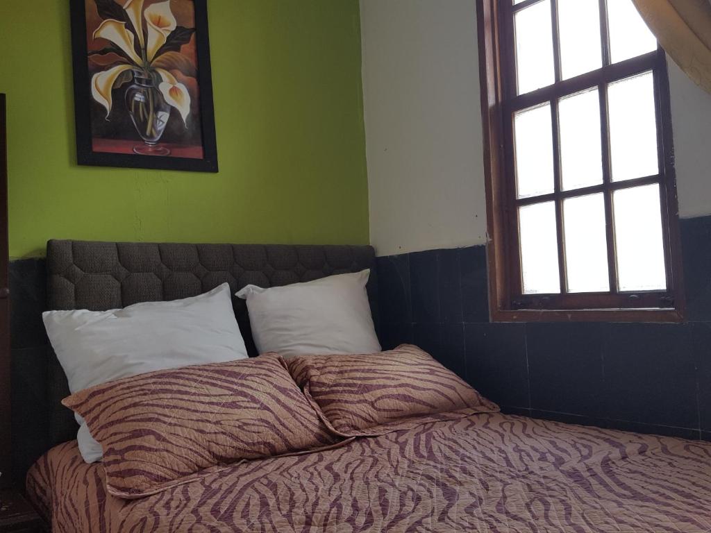 Postel nebo postele na pokoji v ubytování Hostal del Piamonte