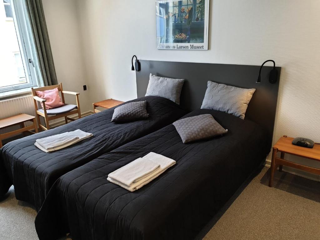 Postel nebo postele na pokoji v ubytování Hotel Aabenraa
