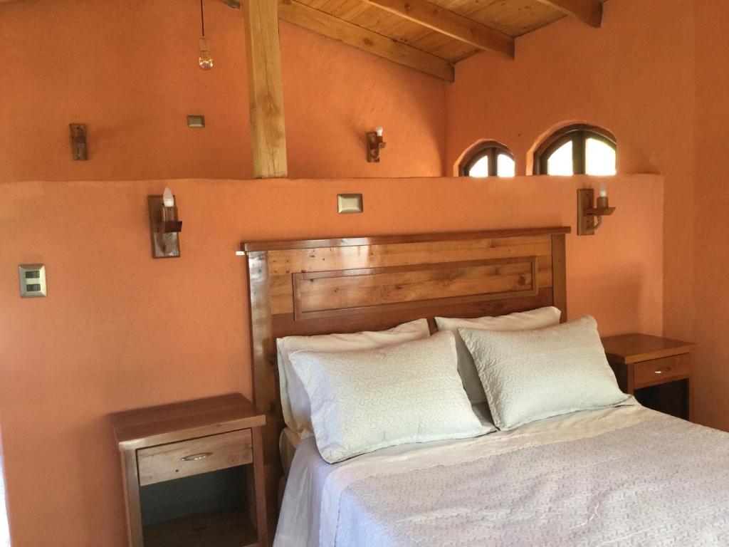 En eller flere senge i et værelse på Cabañas Terra Pocuro