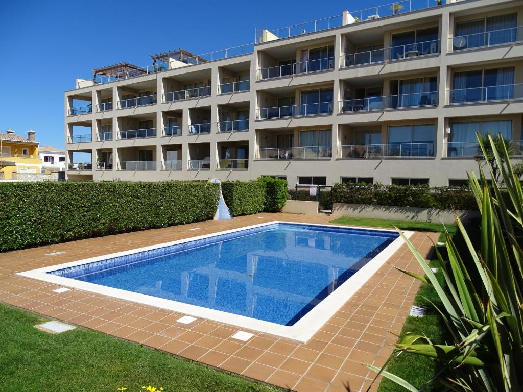 uma piscina em frente a um edifício em Casa Afonso Henriques no Burgau