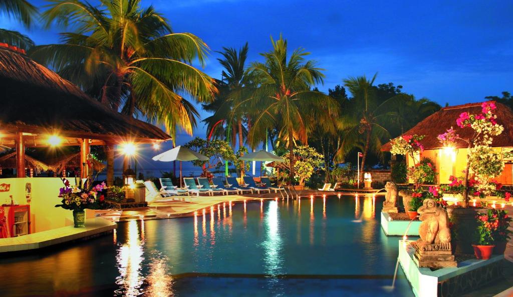 a swimming pool at a resort at night at Aneka Lovina Villas & Spa in Lovina