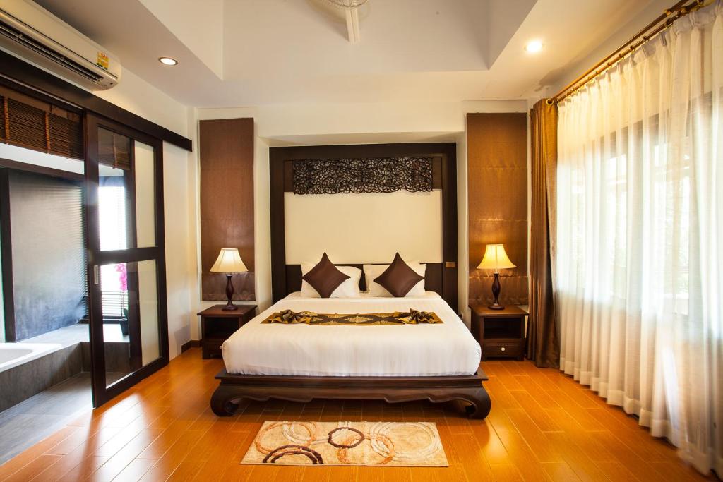 Ein Bett oder Betten in einem Zimmer der Unterkunft Pattra Vill Resort