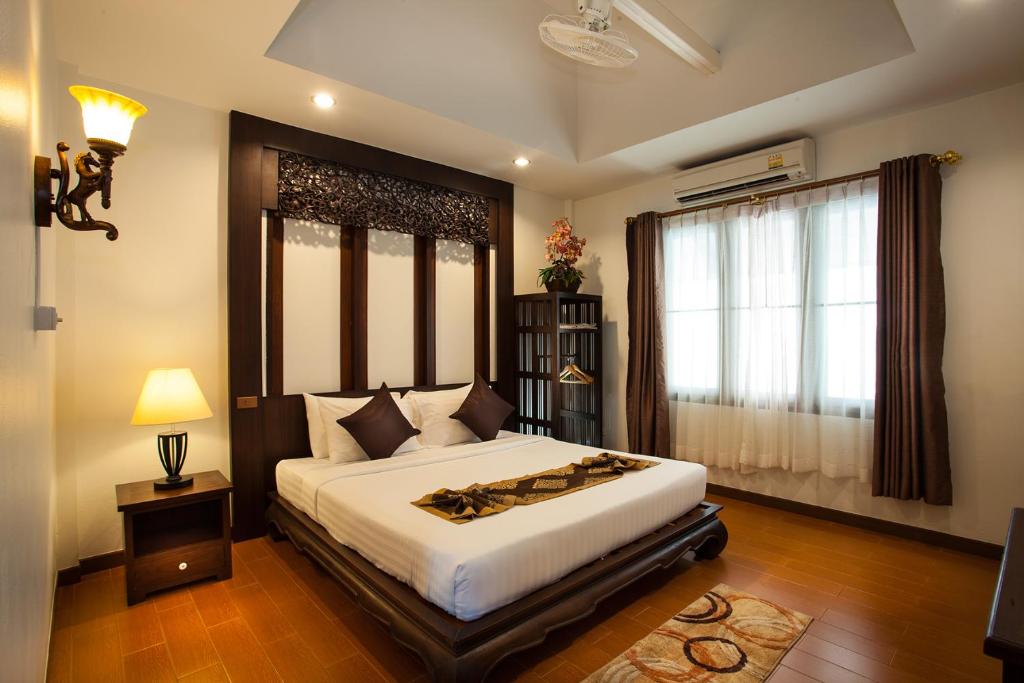 Ein Bett oder Betten in einem Zimmer der Unterkunft Pattra Vill Resort