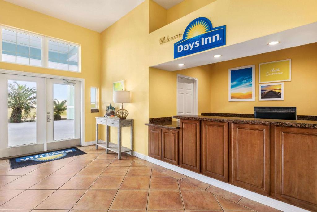 a hotel room with a large sign on the wall at Days Inn by Wyndham Port Aransas TX in Port Aransas