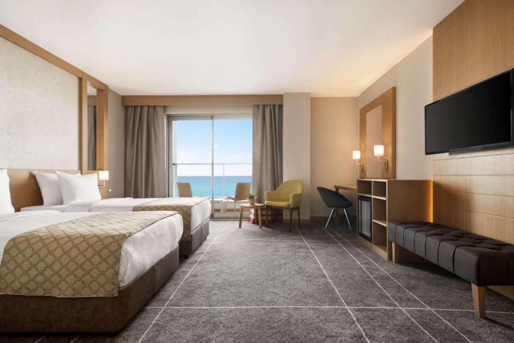 A bed or beds in a room at Ramada Resort by Wyndham Unye