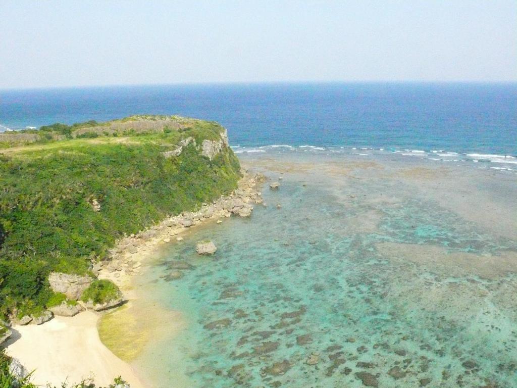 an aerial view of a beach and the ocean at Maru House in Uruma