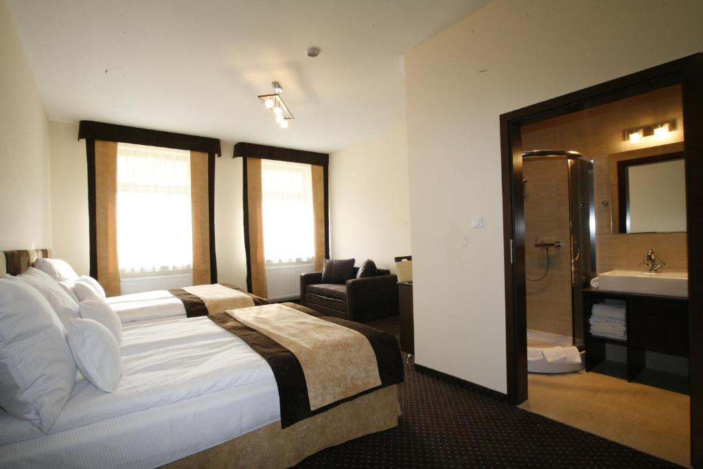 Postel nebo postele na pokoji v ubytování Boutique Hotel's I Milionowa