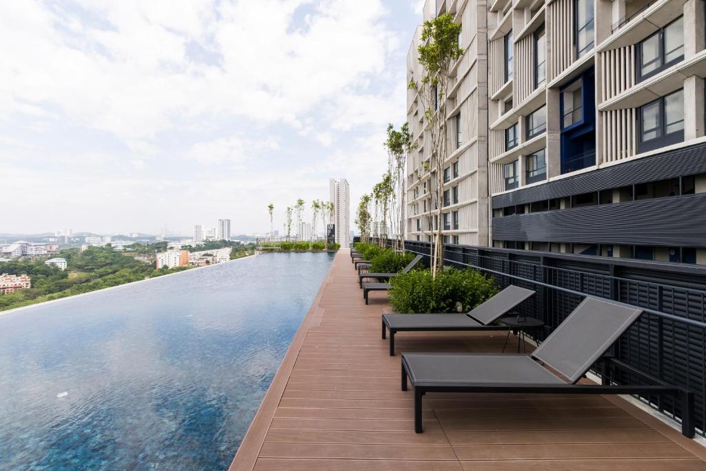 a swimming pool on the roof of a building at Tamarind Suites@Cyberjaya in Cyberjaya