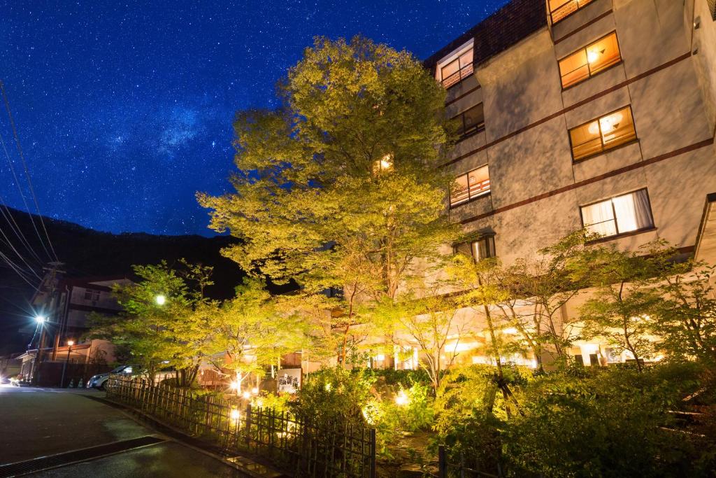 a building on a city street at night at Yuyado Unzen Shinyu in Unzen
